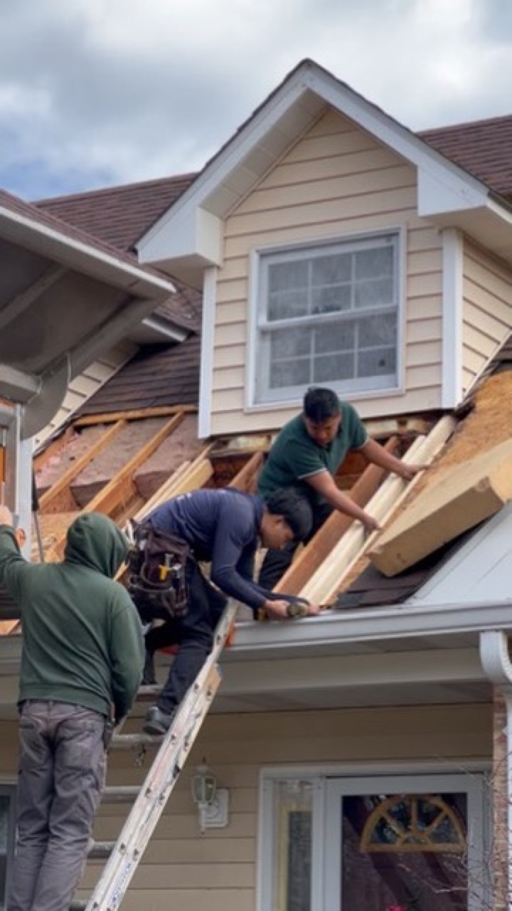 Emmendorfer crew replacing decking during a roof repair